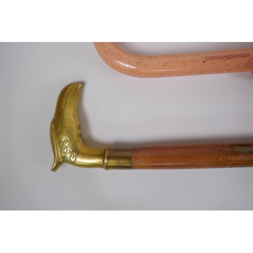 297 - A brass handled walking stick with inlaid brass decoration, together with another walking stick and ... 