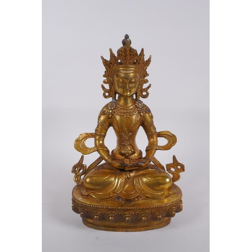 320 - A Sino Tibetan gilt bronze Buddha seated holding a stupa, impressed double vajra mark to base, 28cm ... 