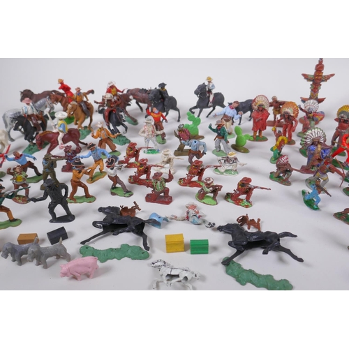 35 - A large quantity of vintage plastic and metal 'cowboy and Indian' toy figures, various makers includ... 