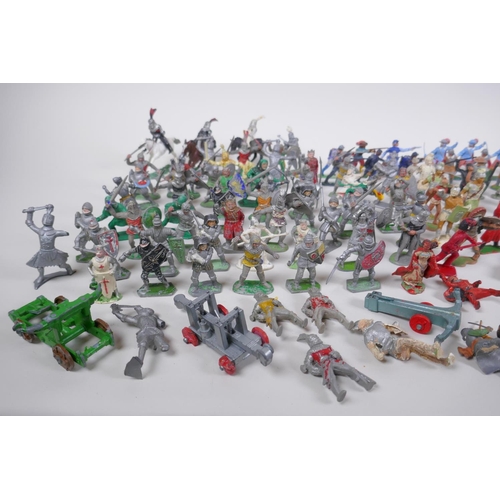 37 - A large quantity of vintage plastic and metal toy soldiers depicting various eras, including medieva... 