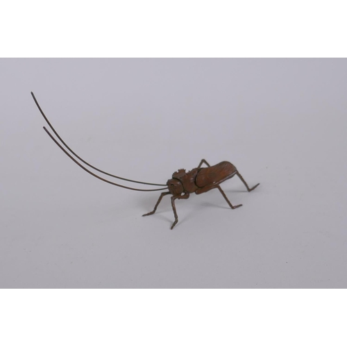 43 - A Japanese style bronze okimono grass hopper with articulated limbs, 14cm long