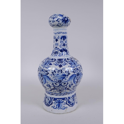 47 - An C18th/C19th Delft blue and white garlic head shaped vase, decorated with birds, flowers and garla... 
