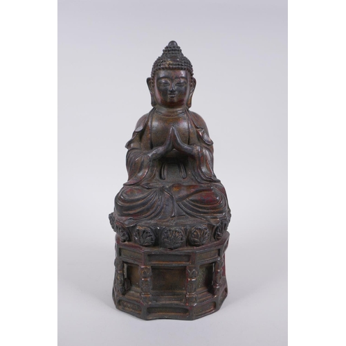 48 - A Chinese bronze figure of Buddha seated on a throne with the remnants of gilt patina, character ins... 