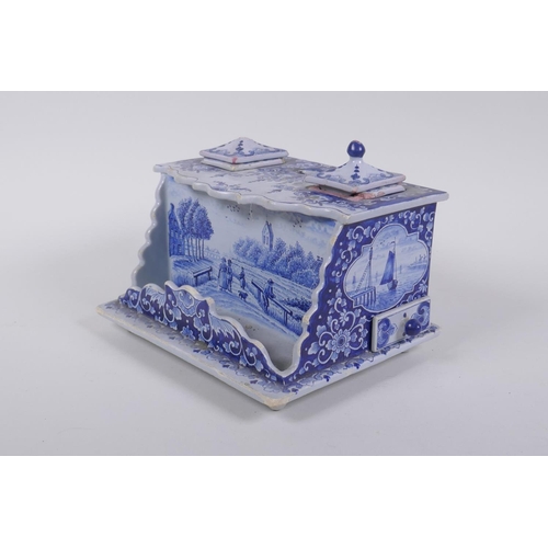 52 - An C18th/C19th Delft blue and white desk stand with twin ink wells, marked Makkum to base, AF, 19 x ... 