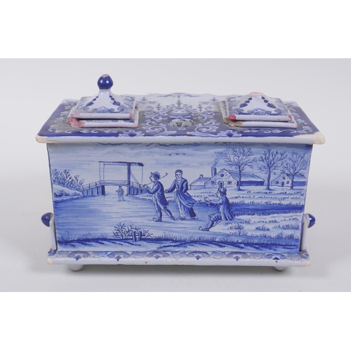 52 - An C18th/C19th Delft blue and white desk stand with twin ink wells, marked Makkum to base, AF, 19 x ... 