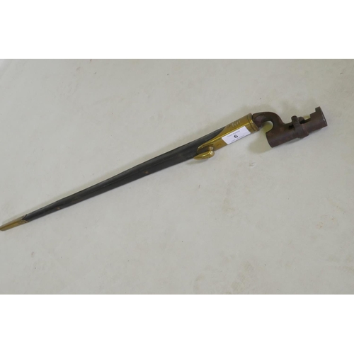 6 - A British Army 1876 pattern socket bayonet in a leather scabbard with brass mounts, stamped WDE7 wit... 