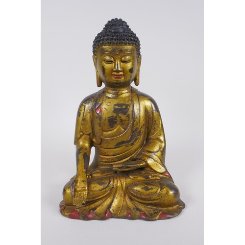 60 - A Chinese gilt and painted bronze figure of Buddha, impressed 4 character mark to the reverse, 27cm ... 