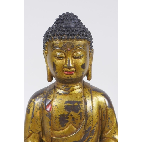 60 - A Chinese gilt and painted bronze figure of Buddha, impressed 4 character mark to the reverse, 27cm ... 