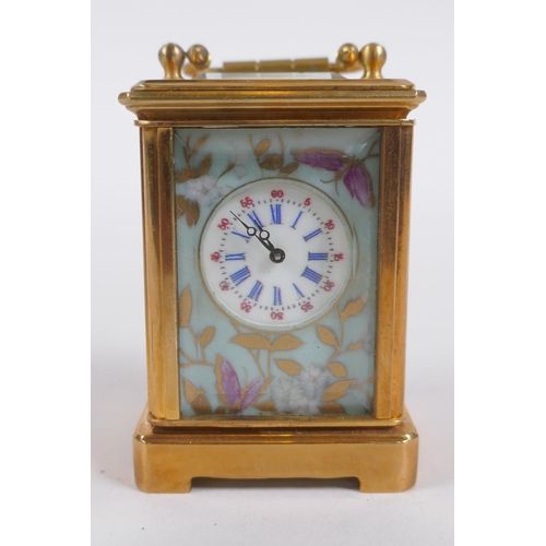 617 - A miniature ormolu and Sevres style porcelain carriage clock, 6cm high