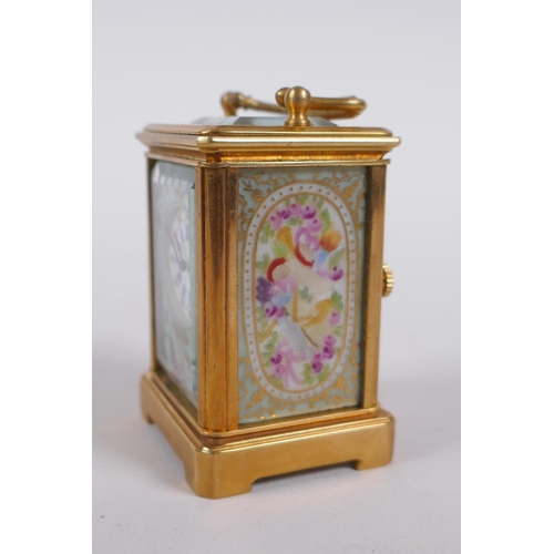 617 - A miniature ormolu and Sevres style porcelain carriage clock, 6cm high