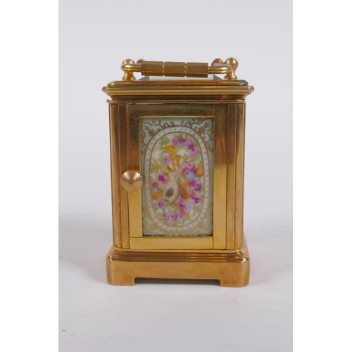 617 - A miniature ormolu and Sevres style porcelain carriage clock, 6cm high