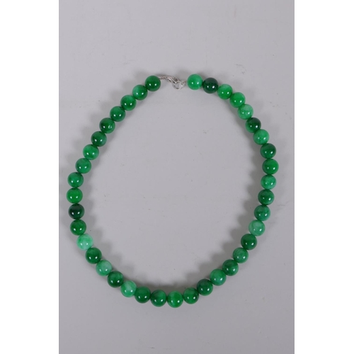 620 - A Chinese apple green hardstone bead necklace, 44cm long