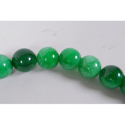 620 - A Chinese apple green hardstone bead necklace, 44cm long