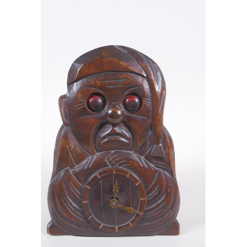 628 - A vintage carved wood figural automaton clock with moving eyes, 18cm high