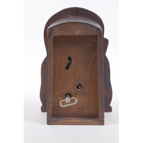 628 - A vintage carved wood figural automaton clock with moving eyes, 18cm high