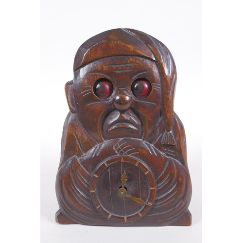 628 - A vintage carved wood figural automaton clock with moving eyes, 18cm high