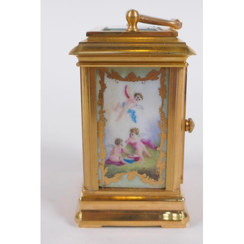 629 - An ormolu and Sevres style porcelain carriage clock with day and date subsidiary dials, 8cm high