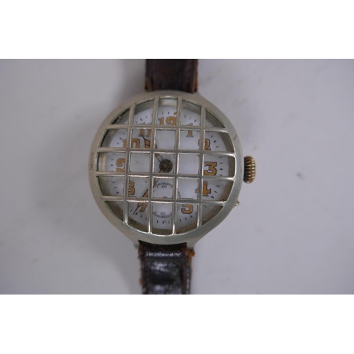 631 - A WWI trench watch, with illuminated Arabic numerals on a shaped white dial with subsidiary second d... 