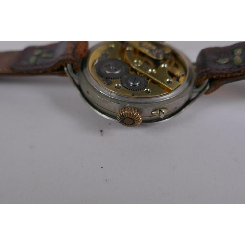 631 - A WWI trench watch, with illuminated Arabic numerals on a shaped white dial with subsidiary second d... 