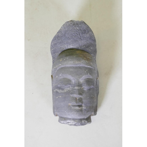 64 - An oriental carved basalt Buddha head, 41cm high