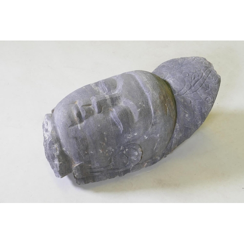 64 - An oriental carved basalt Buddha head, 41cm high