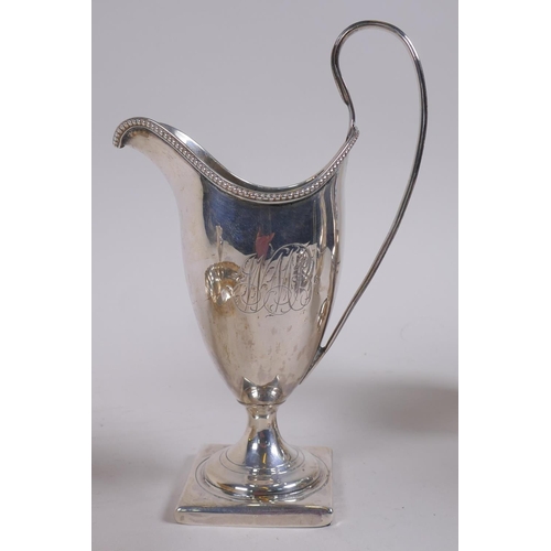 642 - A Georgian silver cream jug, London 1791, makers mark rubbed, handle cracked, 92g, a later silver ju... 