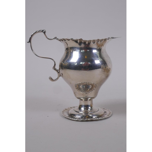 642 - A Georgian silver cream jug, London 1791, makers mark rubbed, handle cracked, 92g, a later silver ju... 