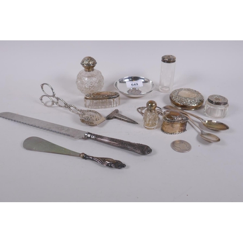 649 - A collection of silver top scent bottles, spoons, a heart shaped pill box, silver half dollar, silve... 