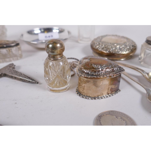 649 - A collection of silver top scent bottles, spoons, a heart shaped pill box, silver half dollar, silve... 