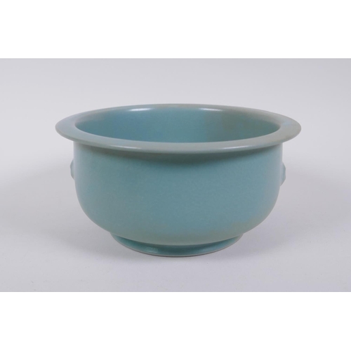 65 - A Chinese ru ware style porcelain steep sided bowl with twin mask handles, 18cm diameter