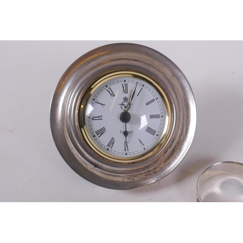 652 - A hallmarked silver easel alarm clock, the dial with R.A.F. crest, 10cm diameter, late C20th, and tw... 