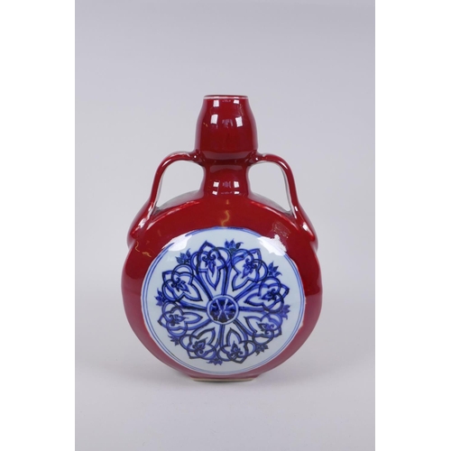 68 - A Chinese sang de boeuf porcelain two handled flask with blue and white floral decorative panels, 4 ... 