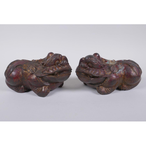 70 - A pair of Chinese filled bronze kylin, with the remnants of gilt and copper patina, impressed 4 char... 