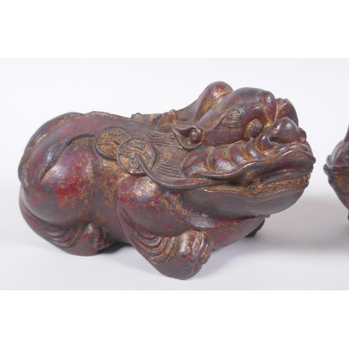 70 - A pair of Chinese filled bronze kylin, with the remnants of gilt and copper patina, impressed 4 char... 