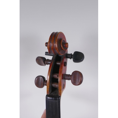 79 - A C19th violin and associated equipment, in a wood case, 59cm long