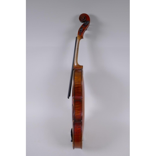 79 - A C19th violin and associated equipment, in a wood case, 59cm long