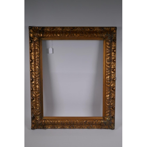 828 - A late C19th gilt picture frame, with leaf and scroll decoration, rebate 61 x 48cm