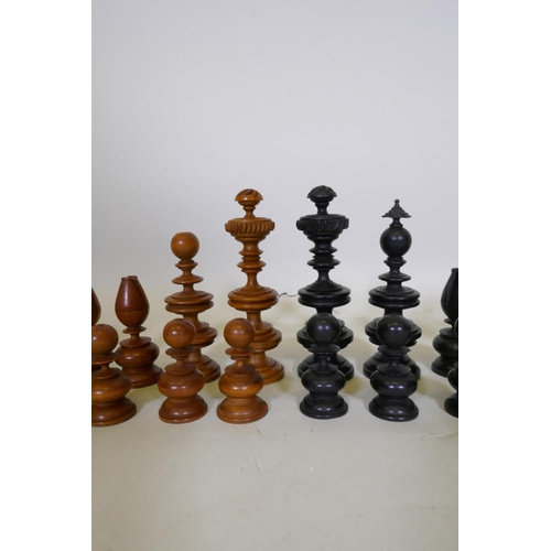 93 - A C19th ebony and boxwood chess set, with fine turned and carved detail, king 11cm high