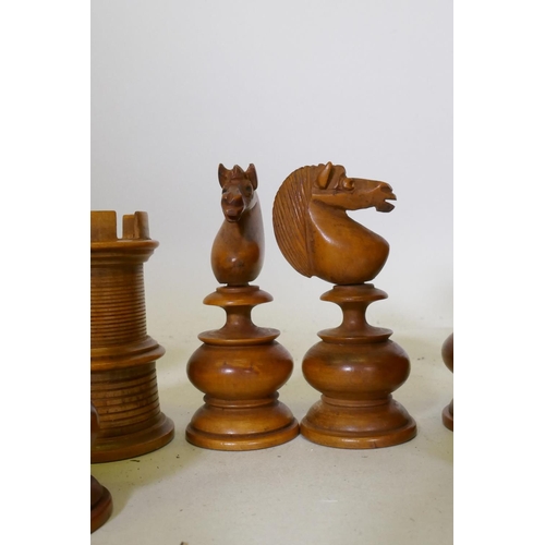 93 - A C19th ebony and boxwood chess set, with fine turned and carved detail, king 11cm high
