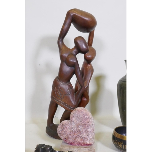 96 - Vanessa Rangisse, a Shona carved soapstone sculpture, 31cm high, an African wood carving, oriental m... 