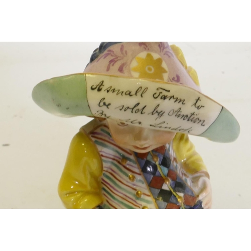 97 - A porcelain Mansion House dwarf, wearing a hat inscribed A Small Farm to be Sold by Auction by Mr. L... 