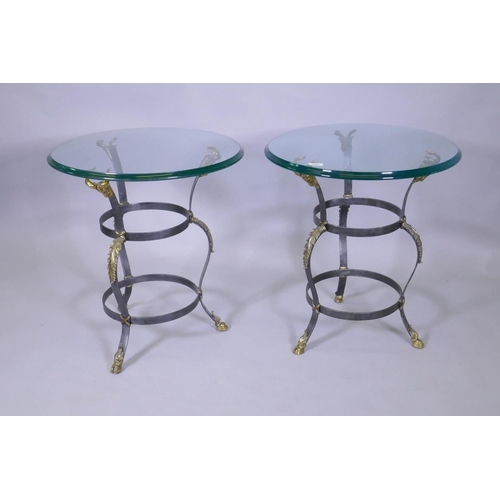 1007 - A pair of Maison Jansen style wrought steel occasional tables with brass mounts, goat's mask decorat... 