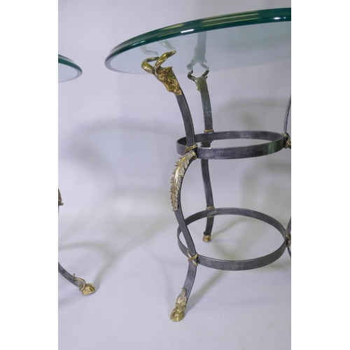 1007 - A pair of Maison Jansen style wrought steel occasional tables with brass mounts, goat's mask decorat... 