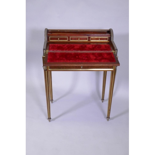 1012 - A French mahogany bonne heure du jour, with brass mounts, the pull out drawer operating the tambour ... 