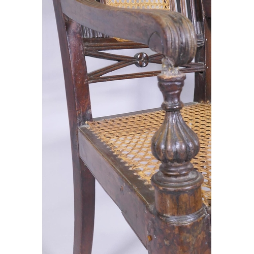 1021 - A C19th Anglo Indian style/Zanzibar hardwood elbow chair, with caned seat and back, reeded arms, rai... 