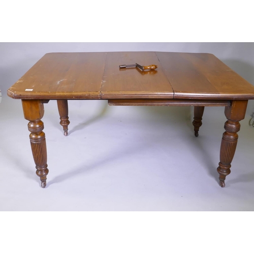 1024 - A Victorian mahogany wind out dining table and leaf, on turned and fluted supports, extended 144 x 1... 