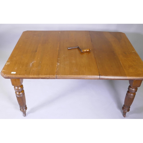 1024 - A Victorian mahogany wind out dining table and leaf, on turned and fluted supports, extended 144 x 1... 