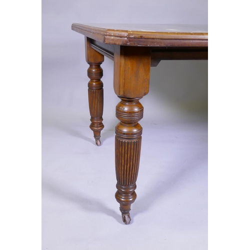 1024 - A Victorian mahogany wind out dining table and leaf, on turned and fluted supports, extended 144 x 1... 