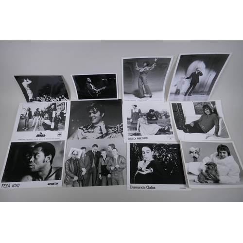 103 - A quantity of black and white press and promotional photographs of musicians, including Elvis, Madne... 