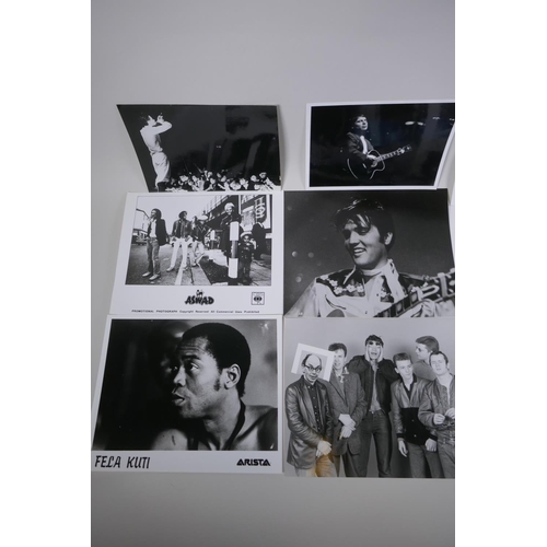 103 - A quantity of black and white press and promotional photographs of musicians, including Elvis, Madne... 